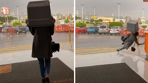 Woman Slips & Falls In Rain After Trying Not To Get Wet