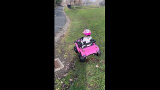 My daughter driving her pink car