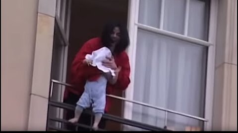 Michael Jackson dangles his baby over a hotel balcony