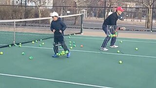 dad teaching kids how to play tennis