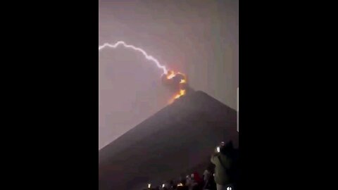 Nature: Violent lightning storm during a volcano eruption.