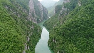 aerial and moving footage through a canyon with beautiful nature and a river below SBV 330788679 HD