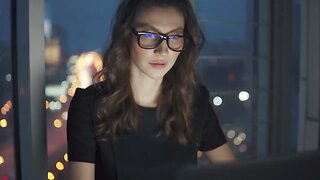 work late at night in the office young woman in business suit and glasses works on SBV 333563373 HD