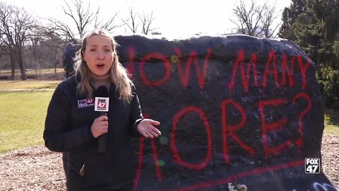 Students paint the rock on the MSU campus with 'How many more?'