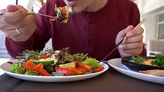man eating lunch with vegetable salad cheese and eggs in restaurant SBV 314370070 HD
