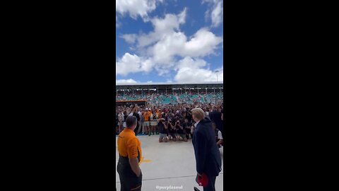 The Crowd chants "USA" as President Trump arrives at the McLaren Garage on Pit Lane