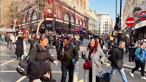 Enthusiastic preacher sings and dances for a crowd in London.
