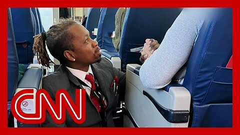 Photo of flight attendant mid-flight goes viral. Hear what he told passenger