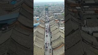 Pingyao is a city in China with preserved medieval buildings and the remaining intact city wall...