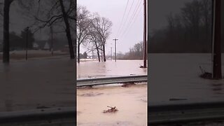 Flooded road over river bridge. Driving over through the water