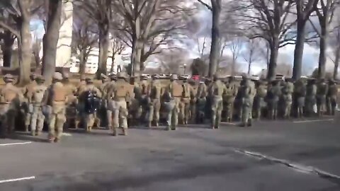 US troops present their backs to the Biden inauguration motorcade. in protest.
