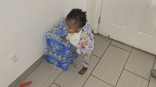 Baby got her foot stuck in a case of water after trying to climb on top of it