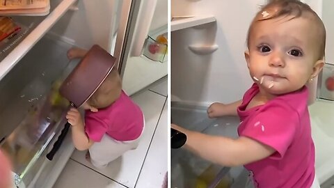 Hungry baby eats rice right out of the fridge