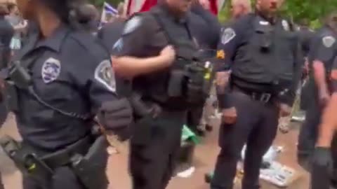 Police Officer Spits On Palestinian Flag