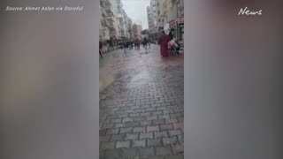 Locals flee as building collapses Into street after Turkish quake