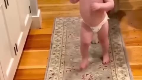 cute baby enjoys playing with dog