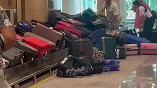 Suitcases Pile Up at Baggage Claim