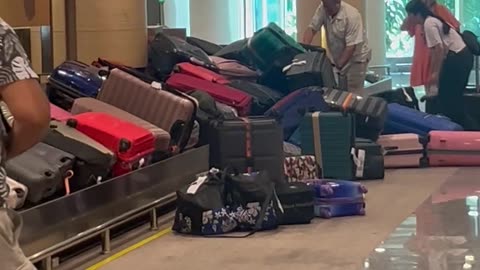 Suitcases Pile Up at Baggage Claim