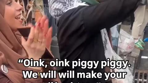 Palestinian protesters taunting American police officers by calling them pigs.