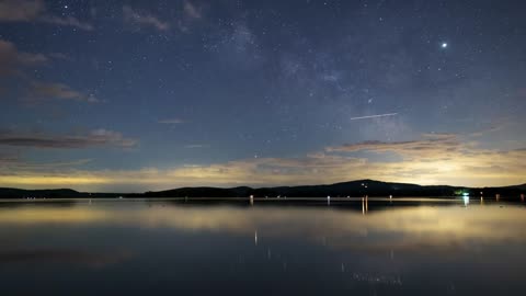 Night sky with stars at a calm lake