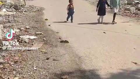 Children Walking Around In The Rubble