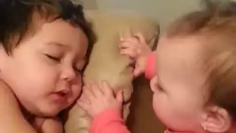 Baby sister tries to wake her big brother