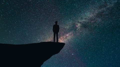 the man stand on the top of a mountain on a starry sky background time lapse Free Stock Footage