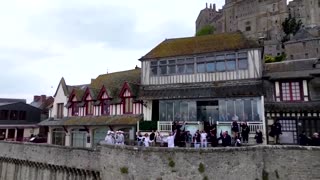Olympic torch arrives at the iconic Mont-Saint-Michel Abbey