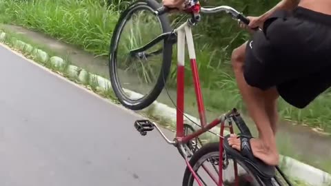 One wheeling bicycle on the road