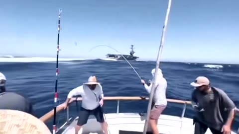 Imagine yourself reeling in a big one, when out of nowhere, the USS Teddy Roosevelt pulls up.