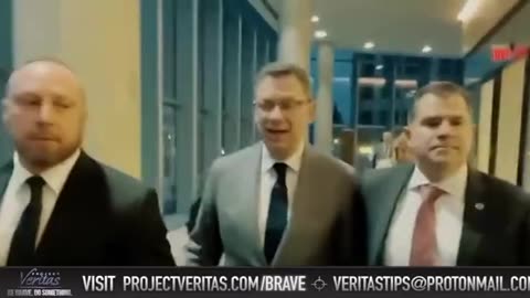 Albert Bourla Confronted by Project Veritas. His Hired Goons Push a Female Reporter Out of the Way,