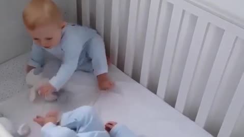 Beautiful twins play together in bed