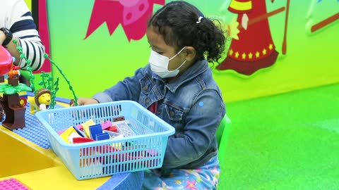 Cute Girl Playing with Toys