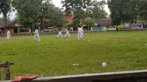 The kids are doing excercise before karate