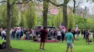 Counter protesters are blasting 'Born in the USA' while waving their USA flags