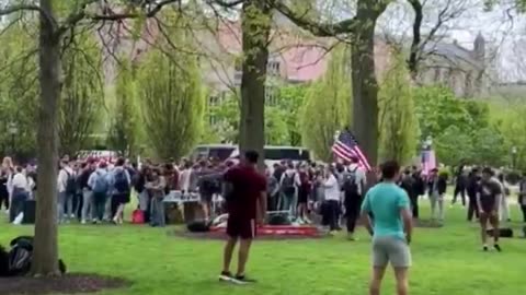 Counter protesters are blasting 'Born in the USA' while waving their USA flags