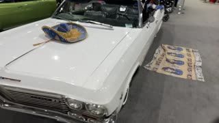 "1969 Chevrolet Impala SS Lowrider in Action: A Gleaming White Classic"