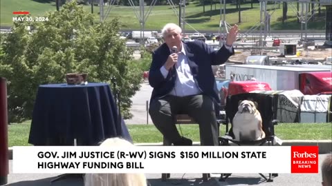 West Virginia Gov. Jim JusticeWith Babydog Alongside HimSigns $150 Million State Highway Bill