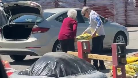 Elderly Couple Works Together