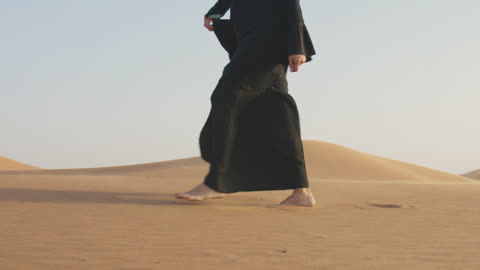 Close-up of an unrecognizable muslim woman walking. Slow MO