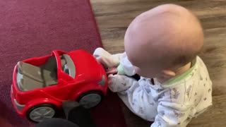 Sammy playing with a car