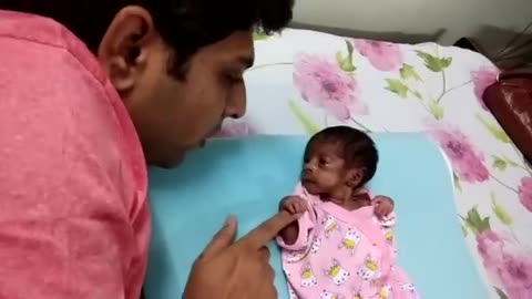 premature baby born 30 weeks miracle baby cute baby playing with Dad