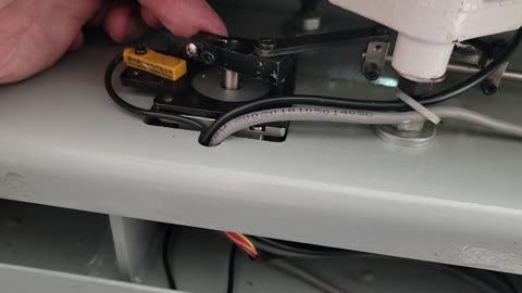 Resetting the trim knives on an embroidery machine.