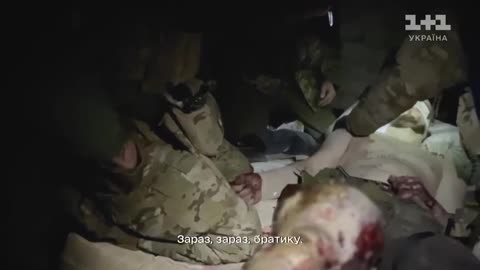 Ukrainian Soldiers Pull Others Out of a Burning Vehicle After Russian Drone Strike