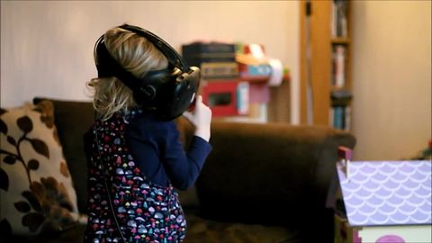 Little girl explores VR dollhouse