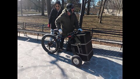 Huge speaker mounted on the front of a modified bike.