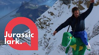 Highlining man crosses Swiss mountain while wearing dinosaur costume