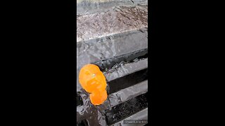 Water falling into a storm drain in slow motion