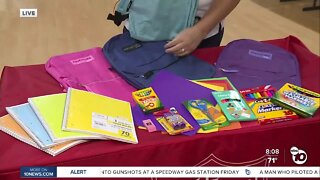 Volunteers stuff backpacks for North County students in need