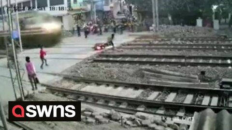 Near death experience when man comes off bike as high-speed train thunders past